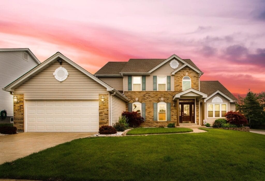 A house with a pink sky in the background