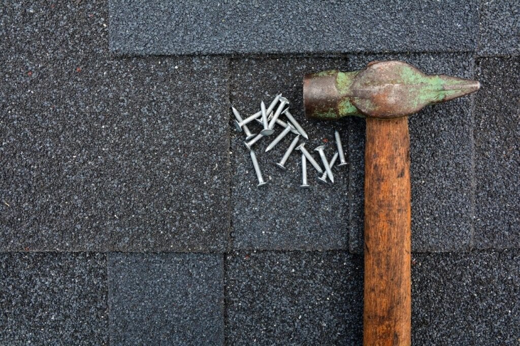 A hammer and some nails on the ground